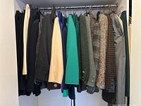 Full rack of jackets and skirts on hangers