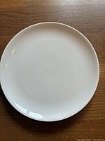 Top view of 12-inch white round serving plate showing smooth surface and clean condition
