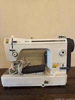 Front view of the Baby Lock Companion 5000 sewing machine with foot pedal and power cord.