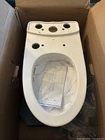 Elongated bowl in original box with installation instructions