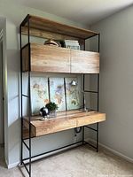 Front view of desk and shelving unit showing raw mango wood surfaces and black metal frame