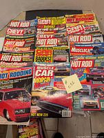 Photo showing the assortment of 15 car magazines with bright cover designs featuring muscle cars, hot rods, and Chevy models