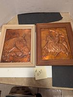 Two copper horse relief pictures with wood frames on a table, showing overall lot contents.