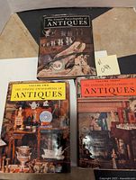 Front cover photo showing Volume One, Two, and Three of The Concise Encyclopedia of Antiques set with detailed images of antiques.