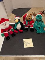 Full set of four holiday TY Beanie Babies in Christmas-themed clothing and colors