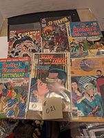 Top view of six comic books laid out, showing full covers including Superman, Archie comics, two Star Trek titles, and Spider-Man.