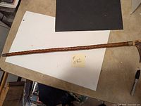 Full view of the 32-inch cane showing the carved wooden shaft and antler handle