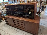 Front view of entire two-piece teak cabinet in showroom