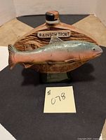 Front view of the rainbow trout decanter showing the fish mounted on the base with the 'Rainbow Trout' label.
