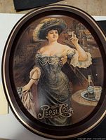 Front view of the oval Pepsi-Cola metal serving tray showing vintage advertising artwork depicting a woman in period dress holding a glass of Pepsi.