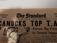 Close-up of The Standard newspaper masthead with date and headline visible, showing typical old yellowed paper condition.