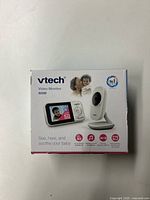 Front of the VTech baby monitor box showing monitor and camera with 2.8-inch screen size and product features.