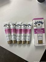 Six tubes of Gold Bond Age Renew Neck & Chest Firming Cream 2 oz displayed on a surface.