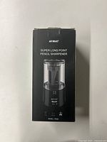 Front of box showing brand AFMAT, product name Super Long Point Pencil Sharpener, and image of the sharpener.