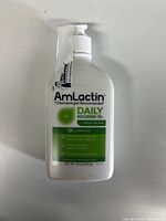 Front view of Amlactin Daily Nourish 12% lotion in 400g pump bottle showing brand, dosage and purpose labels.