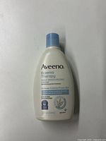 Front view of Aveeno Eczema Therapy Daily Moisturizing Cream bottle showing branding, product name, and usage claims.