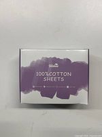Front face of the product box showing Biloban 100% cotton sheets branding with purple and white design.