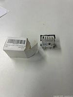 Photo of Dusledel DG44 gadget with packaging box showing front and side view.