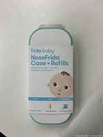 Front view of NoseFrida Case and Refills packaging showing brand, product type, quantity of accessories included, and cartoon baby graphic.