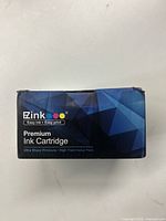 Front side of the blue and black box labeled 'Zink Premium Ink Cartridge' with colorful dots representing ink colors.