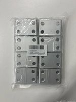 Top view of the 8 silver metal corner brackets arranged in two columns, showing drilled holes in the brackets.