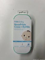 Front view of the Frida Baby NoseFrida Case + Refills packaging showing the product name, baby face illustration, and contents included.