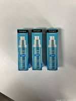 Three boxed bottles of Neutrogena Hydro Boost Hydrating Serum arranged side by side on a white surface.