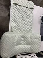 Top view of the ergonomic pillow with textured honeycomb pattern cover laid flat on a white surface.