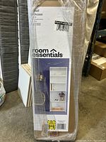 Photo of boxed bookshelf showing brand Room Essentials and product image.