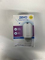 Front view of the boxed Zevo flying insect trap with LED and UV light features and starter kit information.