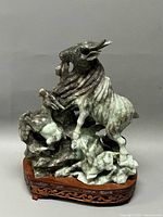 Front and side view of the carved jade goats sculpture on wooden base