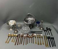 Full lot overview showing bridal basket, candlesticks, flatware, covered glass dish, and containers