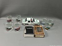 Lot consisting of Hess police car toy, six drinking glasses with police car prints, Precor model 666 pocket radio in box with earphones.