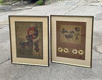 Both framed prints positioned outdoors on pavement