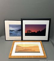 Set of three framed scenic photographs displayed together, showcasing variety in frame styles and scenery.