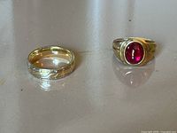 Both rings on reflective surface showing overall appearance