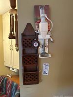 Wooden wall-mounted organizer with three lattice compartments and Bamix immersion blender mounted beside it on a wall, showing overall condition.