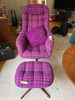 Front view of swivel chair with matching ottoman on metal bases.