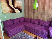 Full view of two modular seating sections joined in L-shape with back cushions installed.