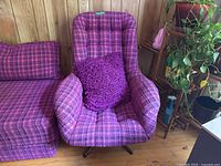 Front view of purple and pink tweed upholstered swivel chair with cushion