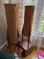 Front view of both lamps side by side against lace curtains