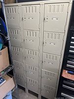 Full view of beige metal locker showing 15 doors