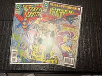 Both comic books in bags side by side