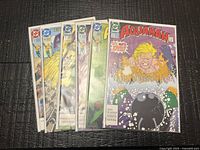 Front view of all six bagged Aquaman comics fanned out