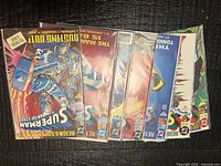 All seven bagged Superman comics laid out overlapping