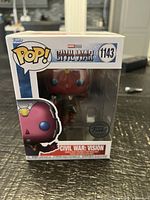 Front of boxed Funko Pop Vision figure