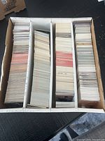 Top view of four-row cardboard storage box filled with trading cards
