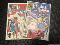 Both comic books side by side in protective sleeves