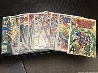 Stack of nine bagged Avengers comics fanned out