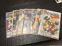 Seven Excalibur comics fanned out on surface